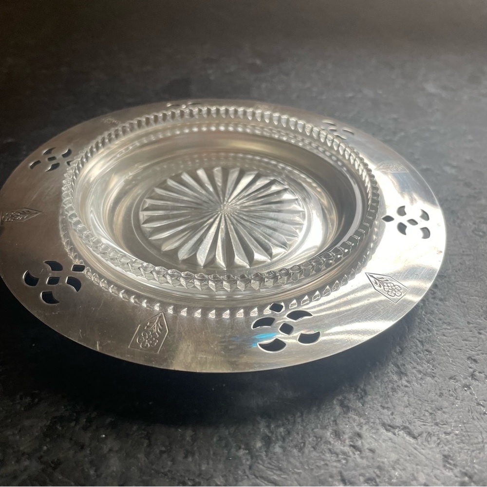 Vintage silver-plated item with a glass insert wine bottle coaster.